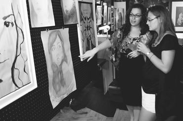 Two women looking at a picture of a woman.