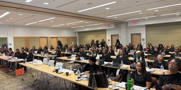 Large group of women attending a seminar in a conference room.