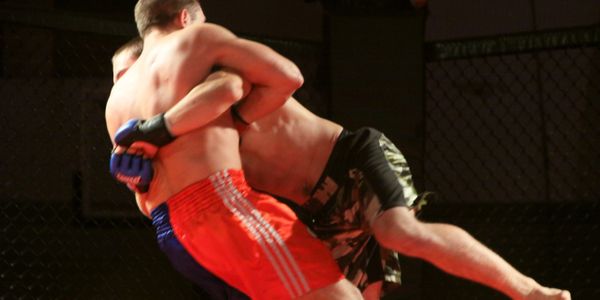 Dustin Alexander executes a high clinch in MMA competition