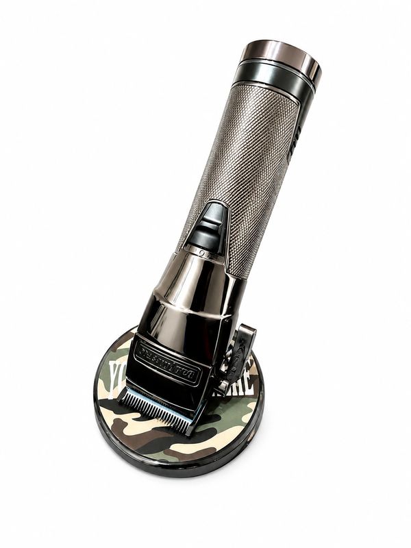 A sleek, metallic hair clipper resting on a camouflage-patterned base.