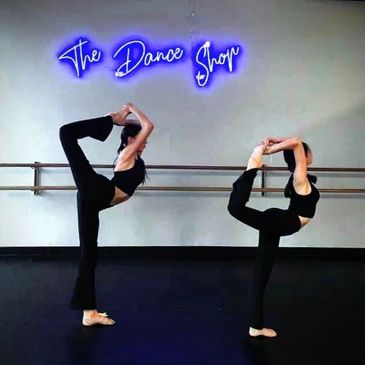 dancers showing off their skills stretching their legs behind them and toward the ceiling