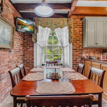 Cozy dining area with exposed brick walls and wooden accents.