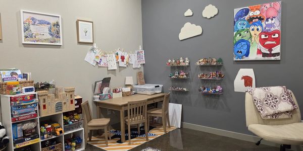 Cozy kids' playroom with toys, art supplies, and colorful decorations.