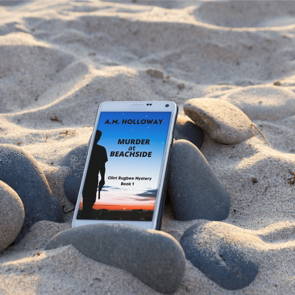 Phone on beach sand displaying 'Murder at Beachside' mystery book cover.