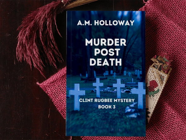Book titled 'Murder Post Death' by A.M. Holloway on a dark wooden table.