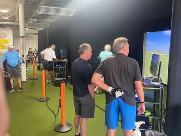 men reviewing SkyTrak results
