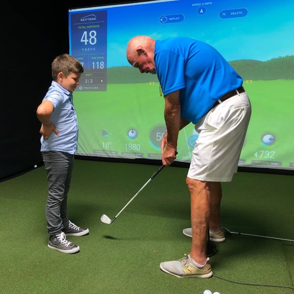 junior golfer getting lesson