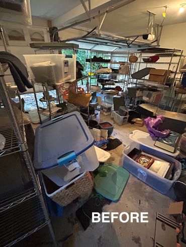 Cluttered garage filled with plastic bins and shelves before organizing.