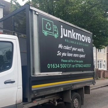 A Junkmove truck parked on a street, advertising waste collection services.