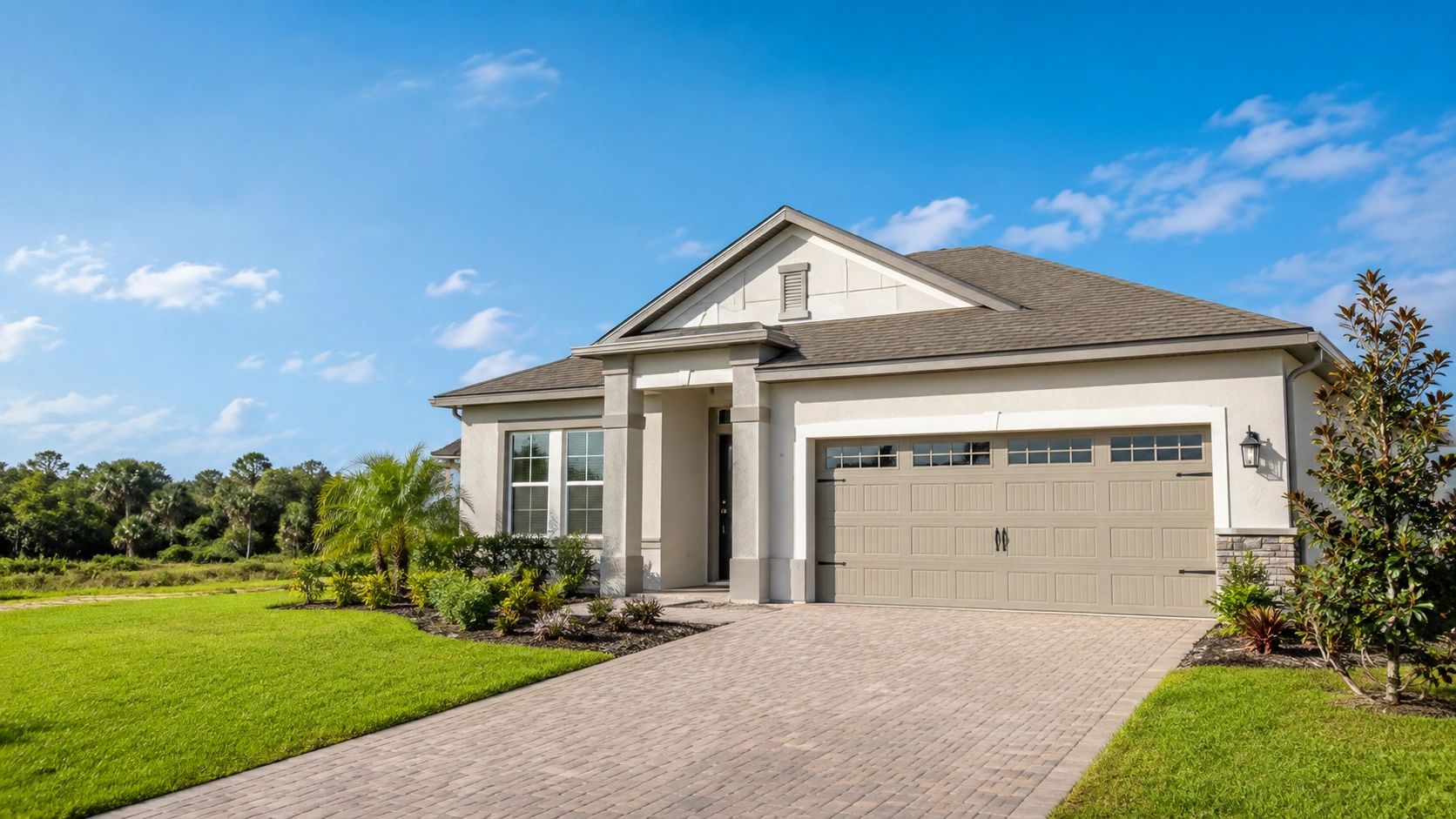 Modern house with a spacious driveway and clear blue sky.