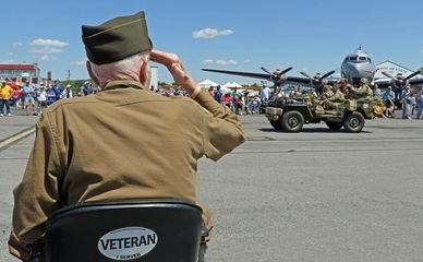 Veteran in uniform saluting at WWII Weekend.