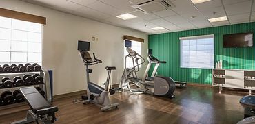 Workout area with an elliptical and weights.