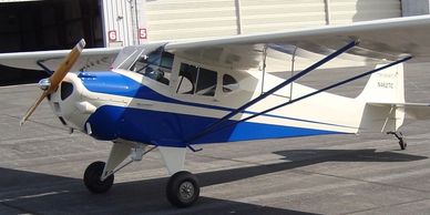 A small white and blue aircraft that has been worked on Steve's Landavator Serveices LLC.
