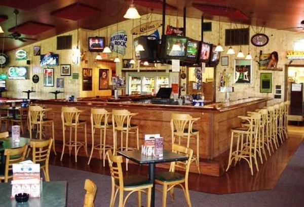 Picture of wooden chairs at wooden bar.