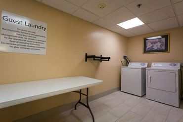 Guest laundry room with washer and dryer.