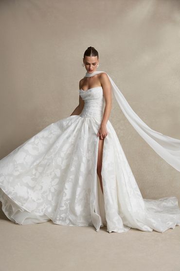 Drop waist wedding dress with classic flower details, exposed boning, and a matching scarf