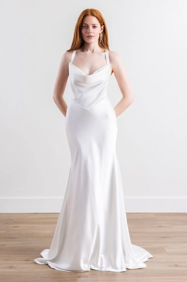 A classic satin wedding gown with a draped bodice and basque waist