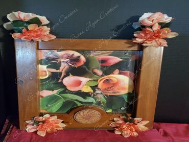 Cabinet side panel turned into a photo frame. Whimsical fairies were placed among the lillies and so