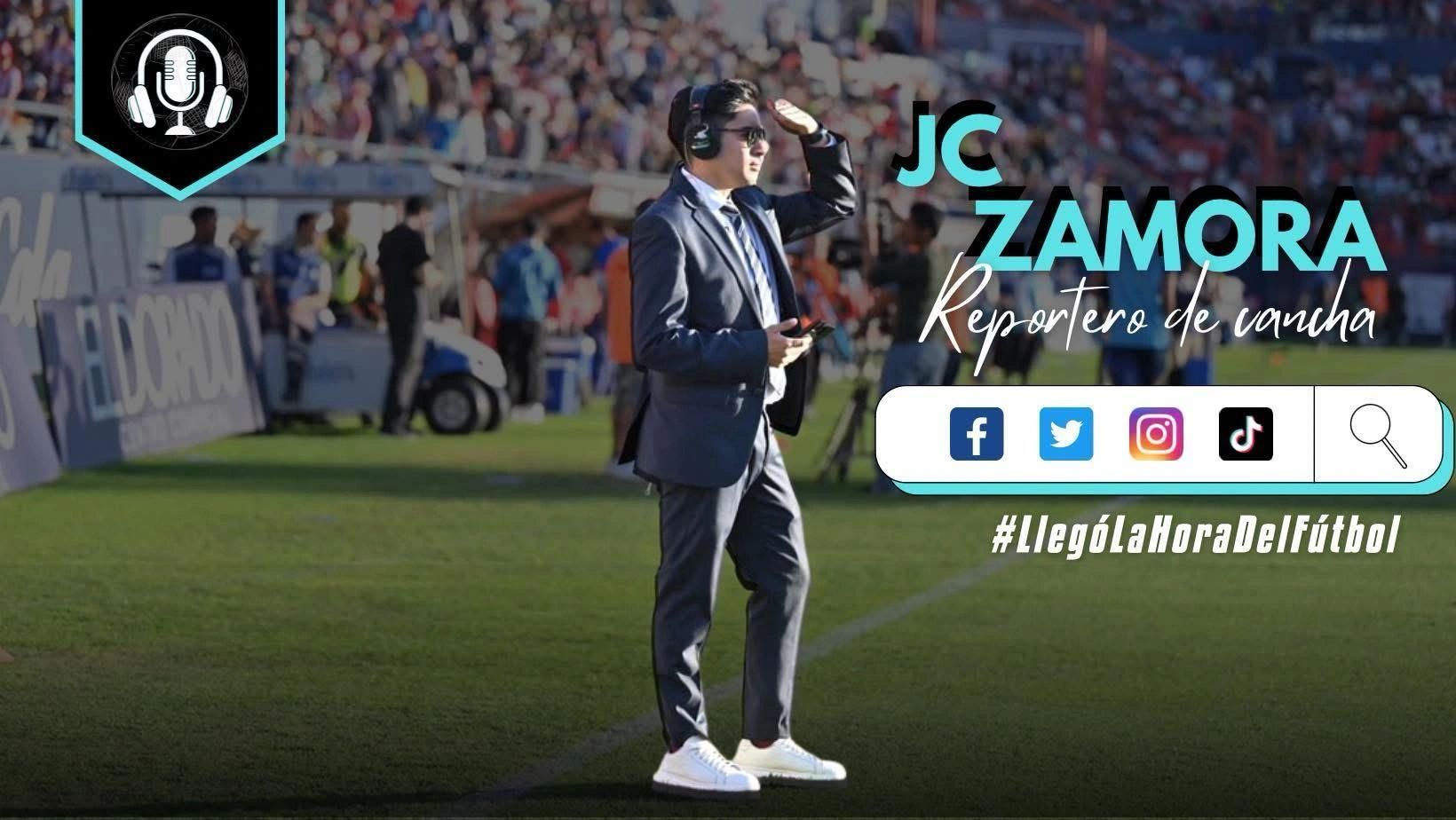JC Zamora, a soccer reporter, stands on the field with headphones and a microphone.