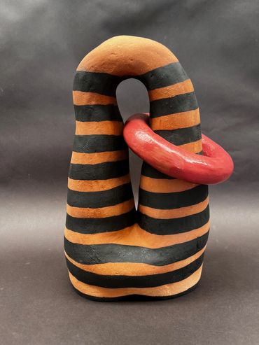 Complete Control Abstract ceramic sculpture with black and orange stripes and a red ring.