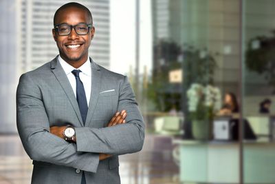 A man wearing blazer Eyeglass And looking ahead