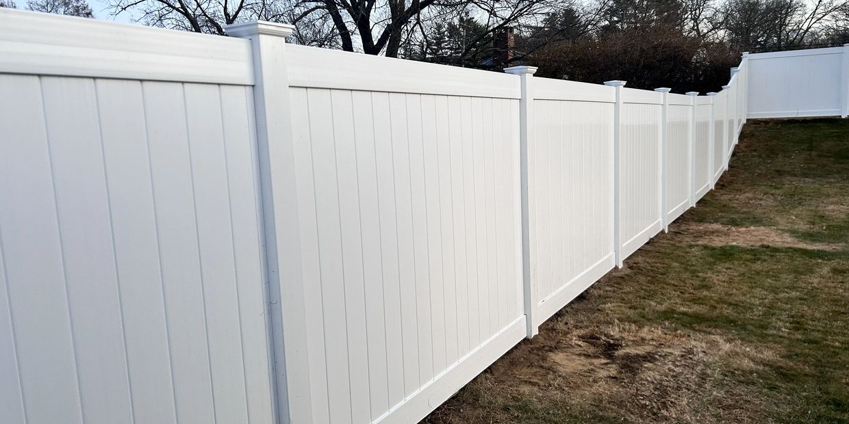 Enfield Vinyl privacy fence installation around a pool.