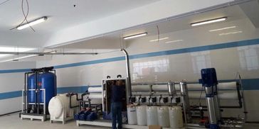 Man working on industrial water filtration system.