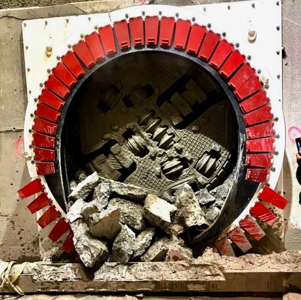 Tunnel boring machine cutting through concrete.