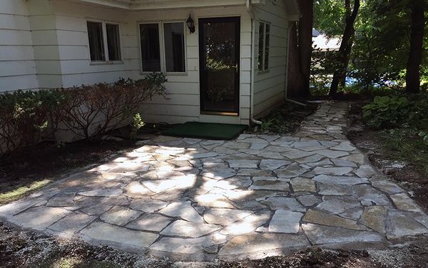 Natural stone patio installed by Aspen Ridge Tree Service