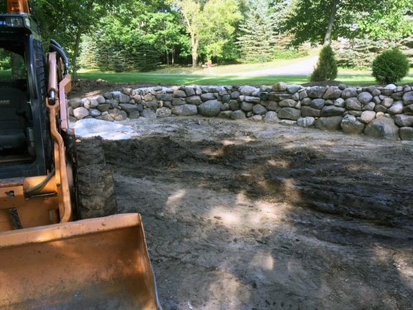 Natural stone retaining wall installation by Aspen Ridge Tree Service