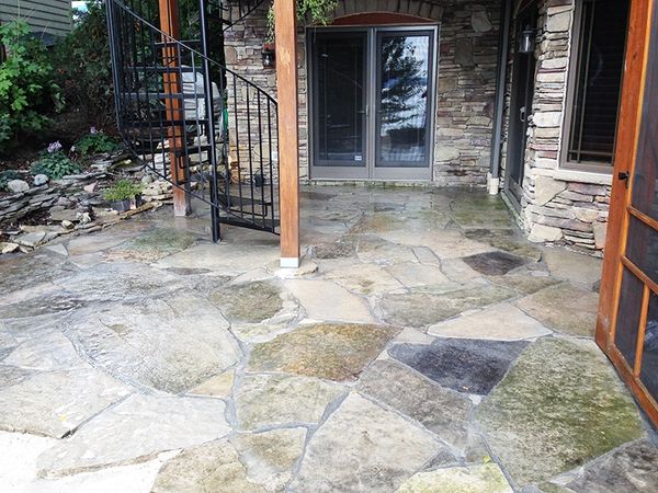 Natural stone patio installed by Aspen Ridge Tree Service
