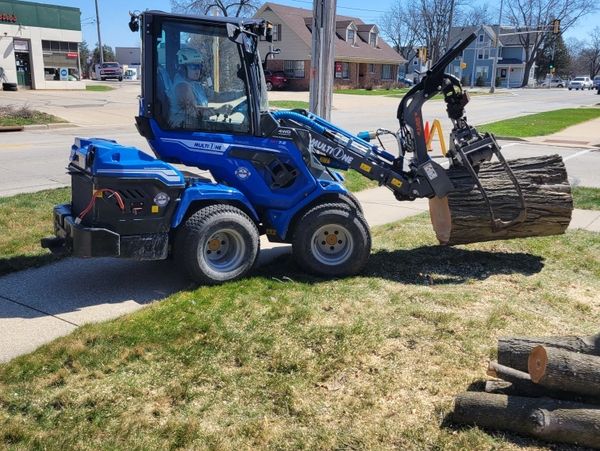 Tree care professional safely moving logs