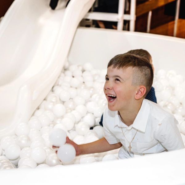 child playing in ball pit