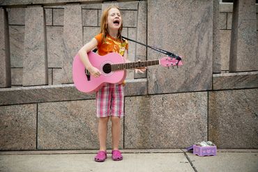 Girl playing guitar and singing