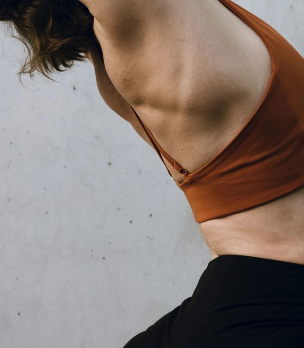Person stretching side in workout attire.