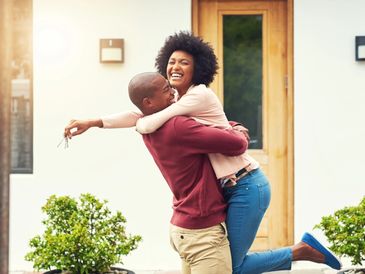 Young couple excited about their new home purchase.