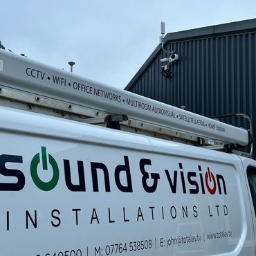 Van with signage for Sound & Vision Installations Ltd under security cameras and tech services.