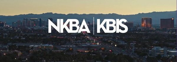 City skyline with NKBA and KBIS logos at dusk.