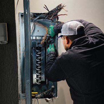 A1-Tex Electric licensed electrician working on a residential electrical panel upgrade with exposed