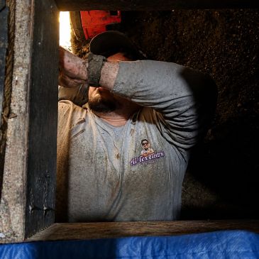 A1-Tex Electric technician working in a crawl space during a residential electrical repair.