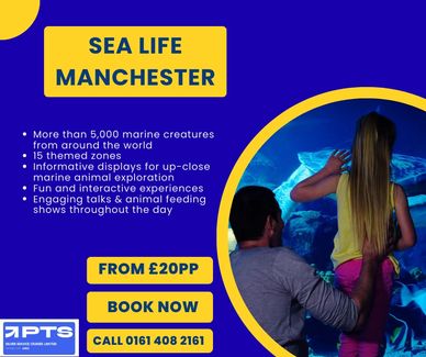 DAD AND DAUGHTER WATCHING FISH IN AN AQUARIUM