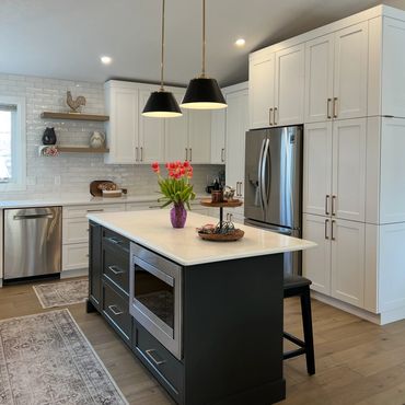 White shaker kitchen with black island and quartz countertop in Grande Prairie.