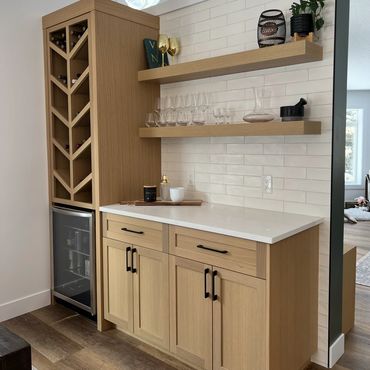 Custom white oak bar cabinet with wine storage and floating shelves in Grande Prairie.