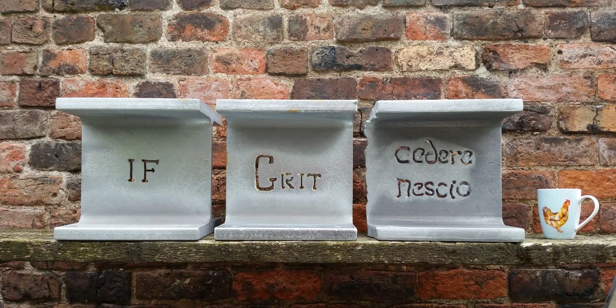 Three brutally simple motivational or inspirational sculptures of words cut into galvanised steel