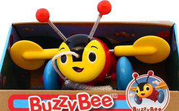 Colorful Buzzy Bee wooden pull toy in packaging.