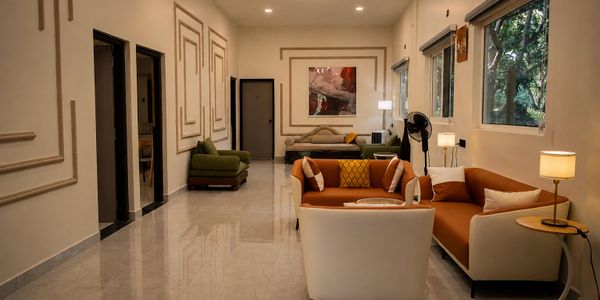Modern living room with elegant furniture and large windows.