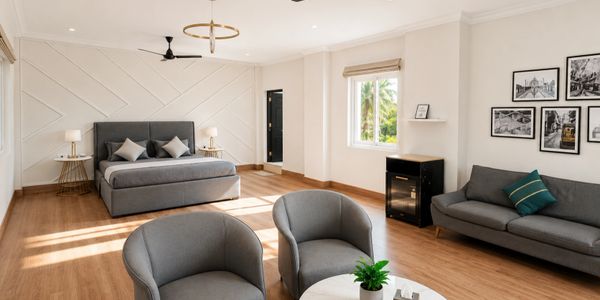 Bright modern bedroom with gray furniture and wooden flooring.