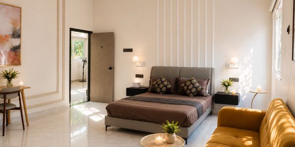 Modern bedroom with a cozy bed, mustard sofa, and natural light.