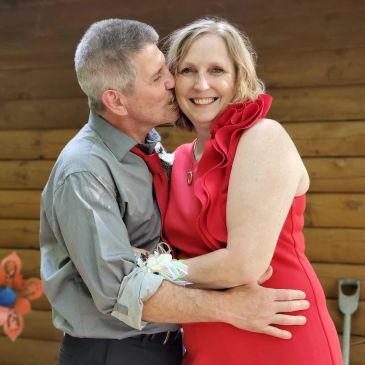 Couple sharing a loving moment with a kiss and hug.