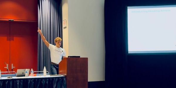 A man presenting at a conference or seminar.